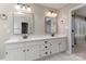 Bright bathroom featuring a double sink vanity, large mirrors, and updated lighting fixtures at 170 W Maranta Rd, Mooresville, NC 28117