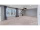 Spacious bedroom with carpet, ceiling fan, and large windows with curtains at 170 W Maranta Rd, Mooresville, NC 28117