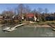 Waterfront home featuring a private dock, lush landscaping, and multi-level deck perfect for lakeside living and entertaining at 170 W Maranta Rd, Mooresville, NC 28117