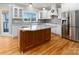 Spacious kitchen with stainless steel fridge, gray backsplash, and granite counters at 170 W Maranta Rd, Mooresville, NC 28117