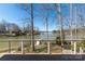 Deck view of a lake featuring a small boat dock, clear skies, and an outdoor patio at 170 W Maranta Rd, Mooresville, NC 28117