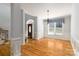 Open living room with wood floors, large windows, and chandelier at 170 W Maranta Rd, Mooresville, NC 28117