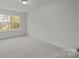 Bright bedroom featuring plush carpeting and a large window at 2013 Near Point Rd # 20, Charlotte, NC 28208