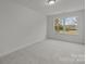 Bright bedroom featuring plush carpeting and a large window at 2013 Near Point Rd # 20, Charlotte, NC 28208