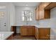 Clean kitchen featuring wooden cabinets, white countertops and backsplash, and a stainless sink at 2013 Near Point Rd # 20, Charlotte, NC 28208