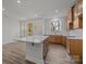 Bright open kitchen with a white island, wooden cabinets, and a door leading outside at 2013 Near Point Rd # 20, Charlotte, NC 28208