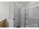 Modern shower with glass doors, integrated shelving and tile surround at 2013 Near Point Rd # 20, Charlotte, NC 28208