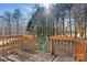 Wooden back deck showcasing natural wood stain and overlooks private wooded backyard at 2107 Summerfield Cir, Conover, NC 28613