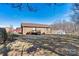 Exterior view of backyard featuring brick home, small wooden deck, and spacious yard at 2107 Summerfield Cir, Conover, NC 28613