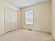 Bedroom featuring a window with blinds and closet at 2107 Summerfield Cir, Conover, NC 28613