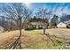 Quaint home with mature trees, a long driveway, and classic brick facade at 2107 Summerfield Cir, Conover, NC 28613