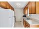 Vintage kitchen features wood cabinets, updated white appliances and laminate countertops at 2107 Summerfield Cir, Conover, NC 28613