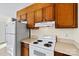 Vintage kitchen features laminate countertops, wood cabinets and white appliances at 2107 Summerfield Cir, Conover, NC 28613