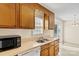 Vintage kitchen with light countertops and wood cabinets near stainless steel sink at 2107 Summerfield Cir, Conover, NC 28613