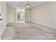 Bright living room featuring neutral carpet, a ceiling fan, and ample natural light at 2107 Summerfield Cir, Conover, NC 28613