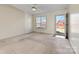 Large living room with neutral carpet, a ceiling fan, and a door leading to outside at 2107 Summerfield Cir, Conover, NC 28613