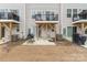View of backyard area with patios, grills, and a grassy area at 2311 Doby Creek Ln, Charlotte, NC 28262