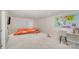 Spacious basement with an orange sectional sofa, ideal for a playroom, media room, or additional living area at 2311 Doby Creek Ln, Charlotte, NC 28262