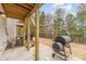 Outdoor patio with grill, and view of wooded backyard and upper-level patios at 2311 Doby Creek Ln, Charlotte, NC 28262