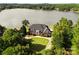 Aerial view of waterfront home with lush landscaping, a sprawling lawn and access to a serene lake at 249 Blue Heron Dr, Rock Hill, SC 29732