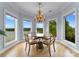 Charming dining room with a decorative chandelier, seating for four, and lake views at 249 Blue Heron Dr, Rock Hill, SC 29732