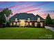 Elegant brick home at dusk, featuring manicured landscaping and a grand entrance at 249 Blue Heron Dr, Rock Hill, SC 29732