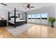 Spacious main bedroom features a decorative canopy bed, hardwood floors, and a large window with lake views at 249 Blue Heron Dr, Rock Hill, SC 29732