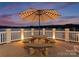 Inviting patio with a stone table and seating, perfect for outdoor dining and relaxation overlooking the lake at 249 Blue Heron Dr, Rock Hill, SC 29732