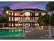 Backyard pool with outdoor seating illuminated at dusk, perfect for evening relaxation at 249 Blue Heron Dr, Rock Hill, SC 29732
