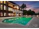 Tranquil backyard pool and patio, ideal for entertaining, with a view of the illuminated home at 249 Blue Heron Dr, Rock Hill, SC 29732