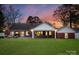 Spacious backyard featuring a well-maintained lawn, brick house, and a covered patio perfect for entertaining at 2701 Sharon Rd, Charlotte, NC 28211