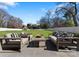 Comfortable patio seating area overlooks the expansive backyard, ideal for outdoor relaxation and entertainment at 2701 Sharon Rd, Charlotte, NC 28211