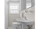 Compact bathroom with a pedestal sink, toilet, and classic white tiling at 2701 Sharon Rd, Charlotte, NC 28211