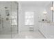 Bright bathroom with double vanity, marble shower, and ample natural light at 2701 Sharon Rd, Charlotte, NC 28211