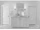 Elegant bathroom with white marble countertop and cabinetry, complemented by sconce lighting at 2701 Sharon Rd, Charlotte, NC 28211