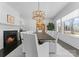 Elegant dining room with a fireplace, a large table, and a stunning crystal chandelier at 2701 Sharon Rd, Charlotte, NC 28211