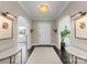 Stylish entryway with dark wood floors, a chandelier, sconces, and views to adjacent rooms at 2701 Sharon Rd, Charlotte, NC 28211