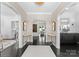 Elegant foyer with dark wood floors, neutral walls, decorative lighting, and arched doorways at 2701 Sharon Rd, Charlotte, NC 28211