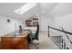 Bright home office featuring a skylight, built-in bookshelves, and desk at 2701 Sharon Rd, Charlotte, NC 28211