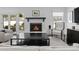 Cozy living room showcasing a fireplace, plush seating, and natural light from surrounding windows at 2701 Sharon Rd, Charlotte, NC 28211