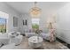 Bright and airy living room featuring stylish furniture and a decorative crystal chandelier at 2701 Sharon Rd, Charlotte, NC 28211