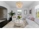 Bright and airy living room featuring stylish furniture, natural light, and decorative plants at 2701 Sharon Rd, Charlotte, NC 28211