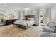 Serene main bedroom with neutral tones, natural light, and an elegant seating area at 2701 Sharon Rd, Charlotte, NC 28211