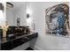 Contemporary powder room with black marble countertop and artistic decor at 2701 Sharon Rd, Charlotte, NC 28211