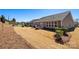 Landscaped backyard featuring a patio area, trimmed hedges, and a well-maintained lawn at 2914 Hiddenbrook Way, Indian Land, SC 29707