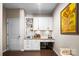 Elegant bar with white cabinetry, granite countertops, and wine storage, perfect for entertaining at 2914 Hiddenbrook Way, Indian Land, SC 29707