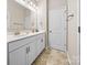 Well-lit bathroom featuring double vanity, white cabinets, and modern fixtures at 2914 Hiddenbrook Way, Indian Land, SC 29707