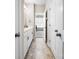 Hallway view of a bathroom with double vanity, doors, and neutral color scheme at 2914 Hiddenbrook Way, Indian Land, SC 29707