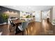 Bright dining room and kitchen offer wood floors, updated lighting, and island seating at 2914 Hiddenbrook Way, Indian Land, SC 29707