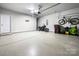 Spacious garage with epoxy flooring, and ample room for storage, clean and organized at 2914 Hiddenbrook Way, Indian Land, SC 29707